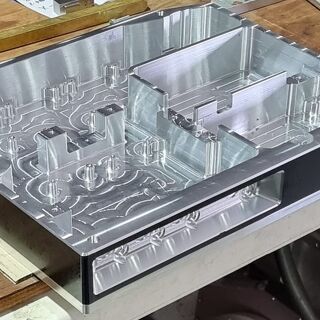 CNC-machined aluminium chassis featuring detailed internal routing and cavities