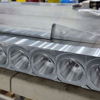 Custom aluminium fixture with multiple precision-machined conical cavities