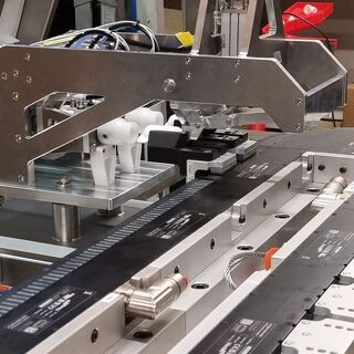 Close-up of an automated pick-and-place assembly line system by TF Design
